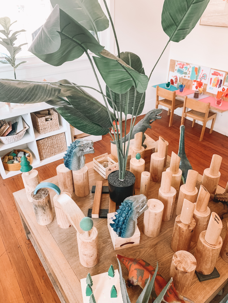 Wooden blocks and dinosaur toys on table at childcare centre
