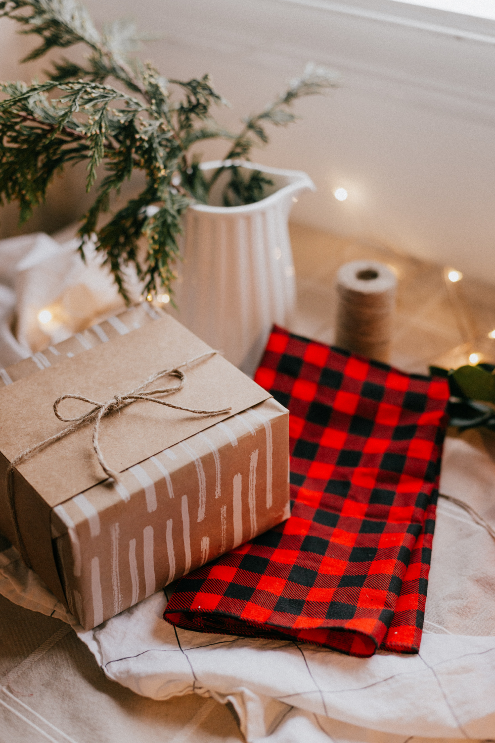 red checked christmas napkin on a table with a gift and a gift box
