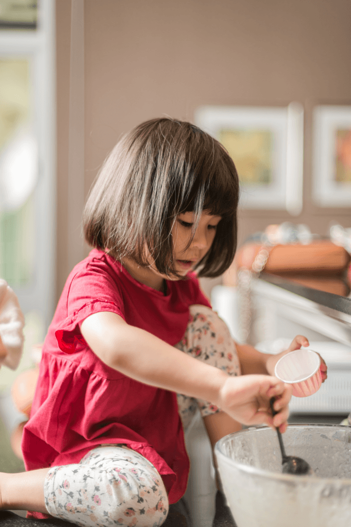 Child cooking with flour and stirring