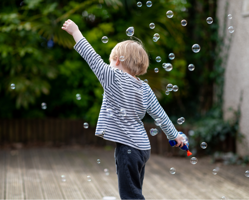 Young toddler playing with bubbles