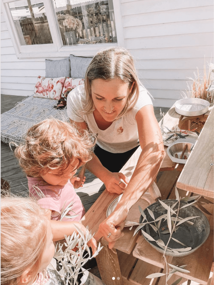 Children playing outside with outisde with supervision of woman