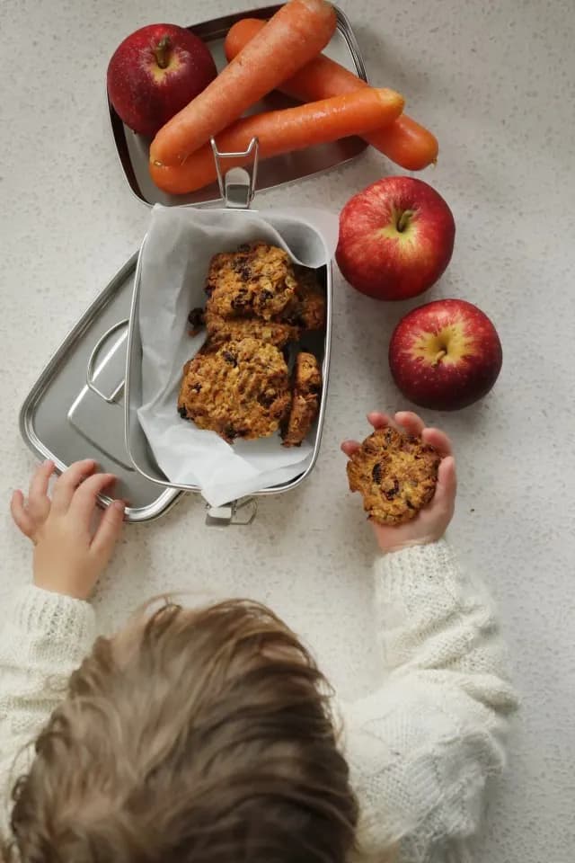 Toddler holding fruit and vege cookie