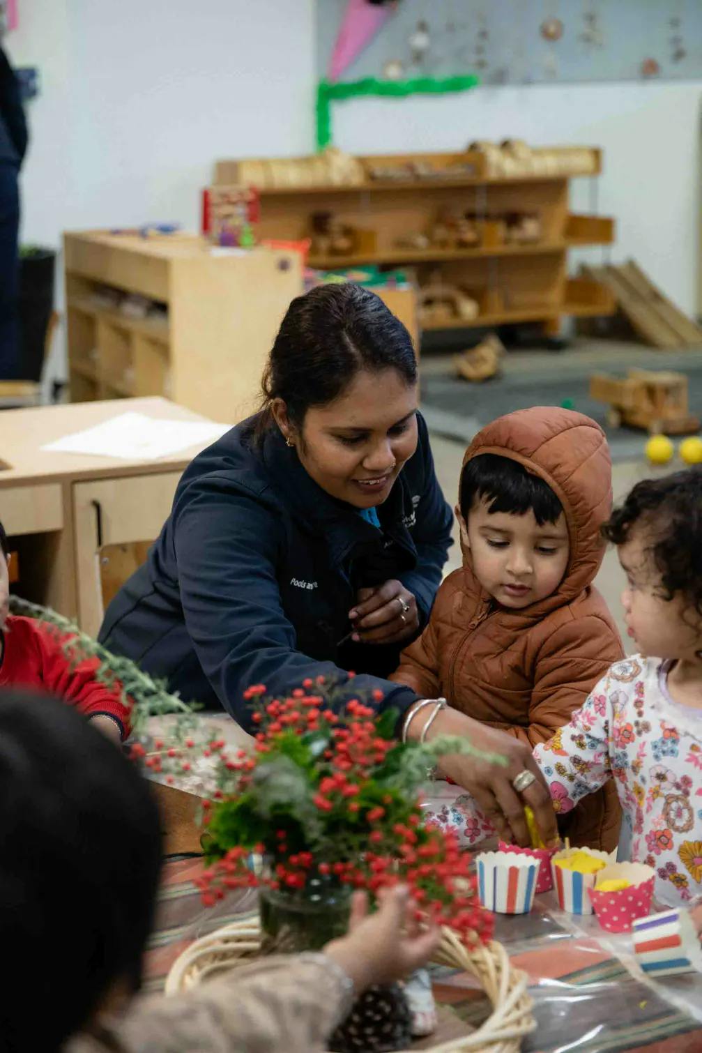 Centre manager Kauri Kids Papatoetoe assisting toddlers