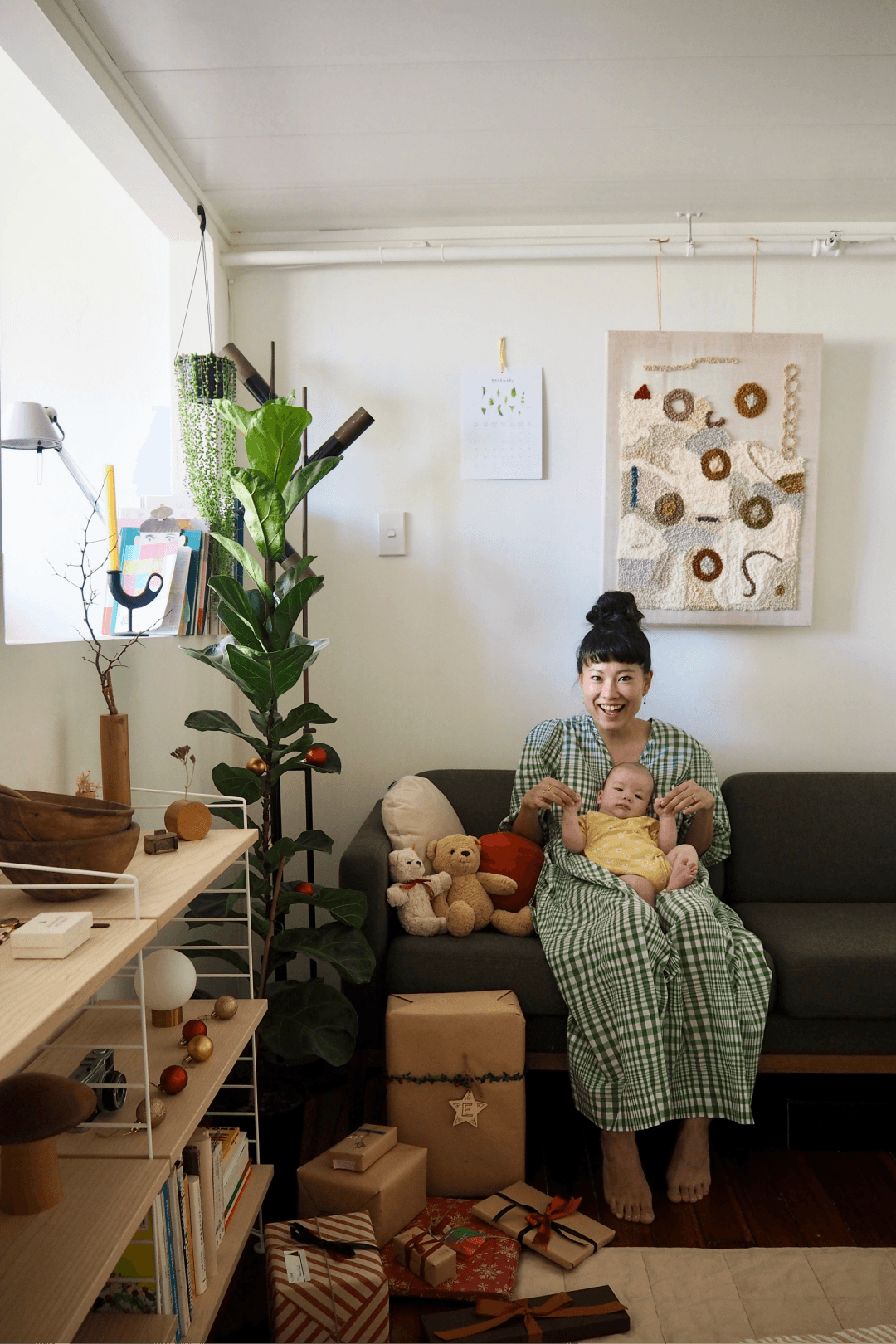 Mother and baby sitting on couch in home